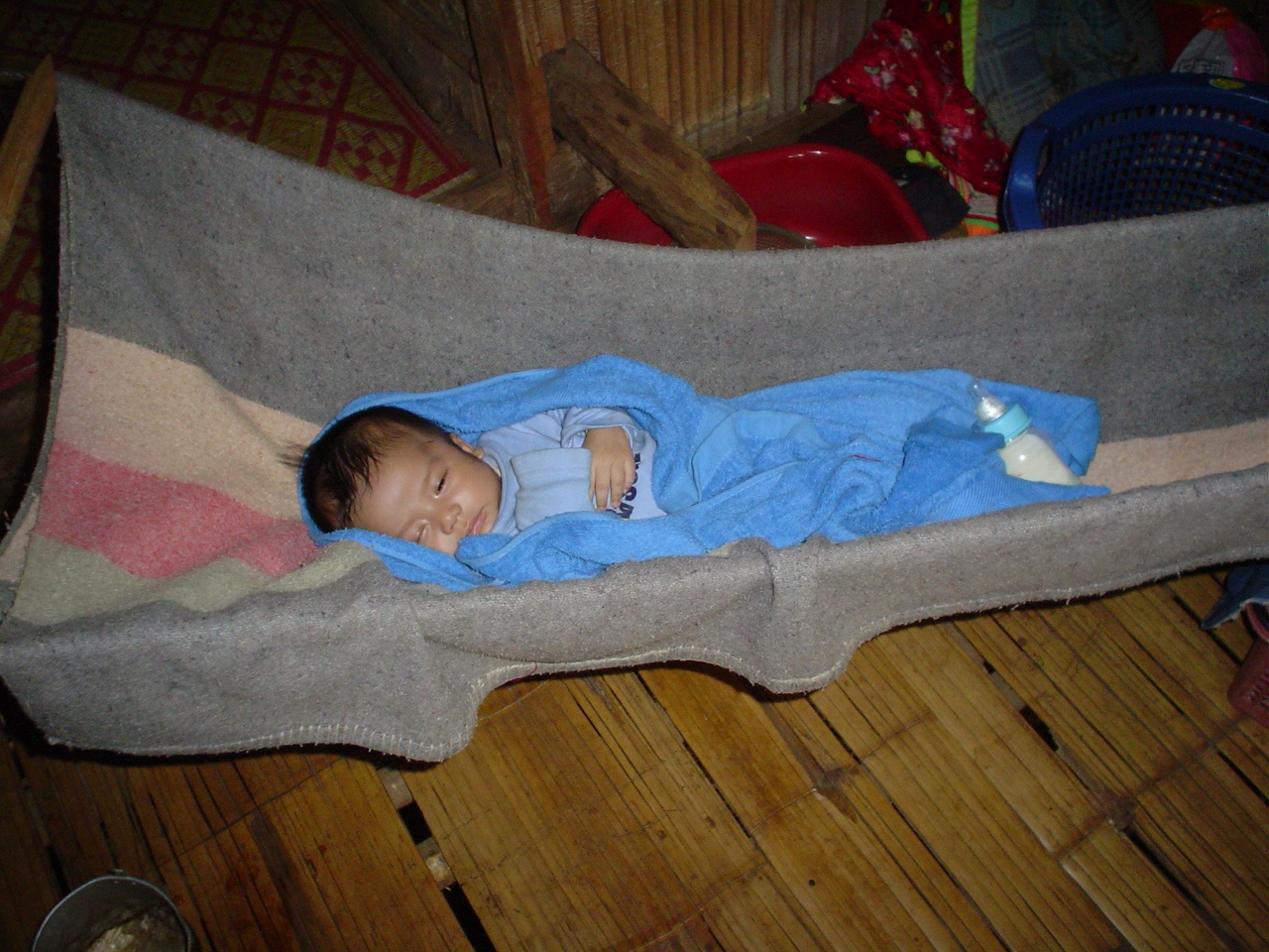 Tiny baby in cloth swing
